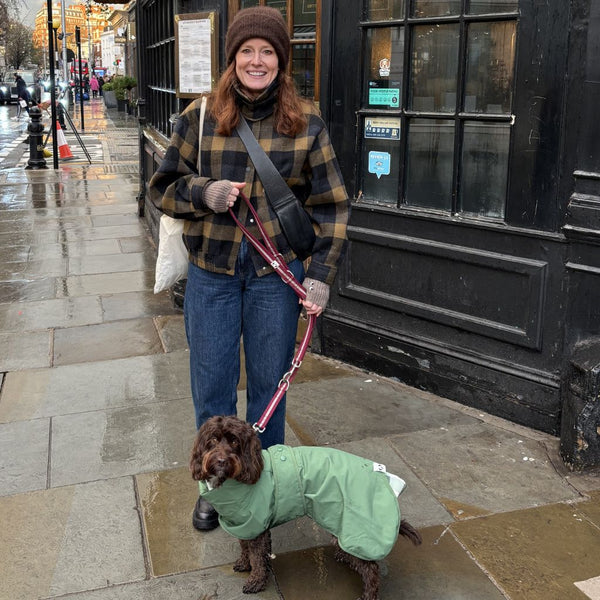 A dog mum walking her dog in the rain