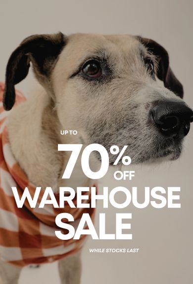 A close-up photo of a dog with large promotional text reading 'UP TO 70% OFF WAREHOUSE SALE' over the center.