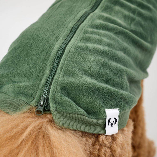 Green fleece dog coat with a zipper and Snoot Style label on a white background