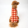 XL Dog wearing an orange check Fleece Dog Coat on a white background.