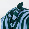A close-up of a striped dog towel robe with a tie back on a white background.