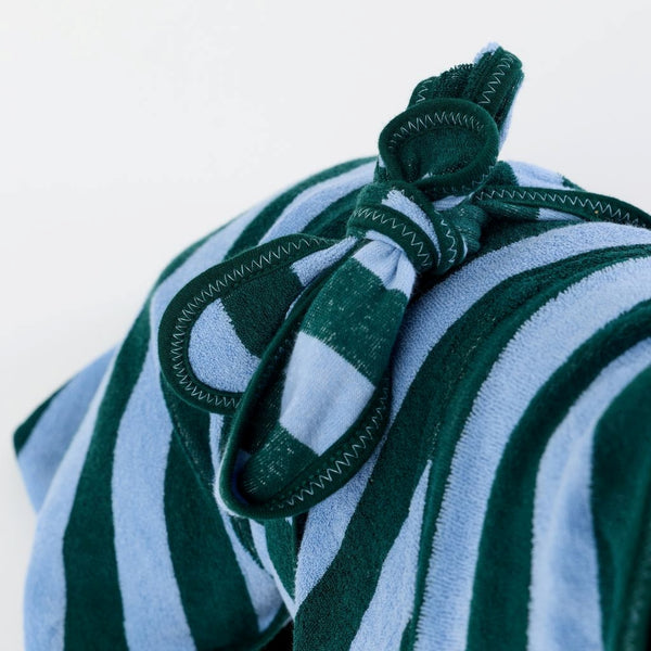 A close-up of a striped dog towel robe with a tie back on a white background.