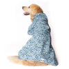 A Golden Retreiver wearing a printed Snoot Style Dog Raincoat.