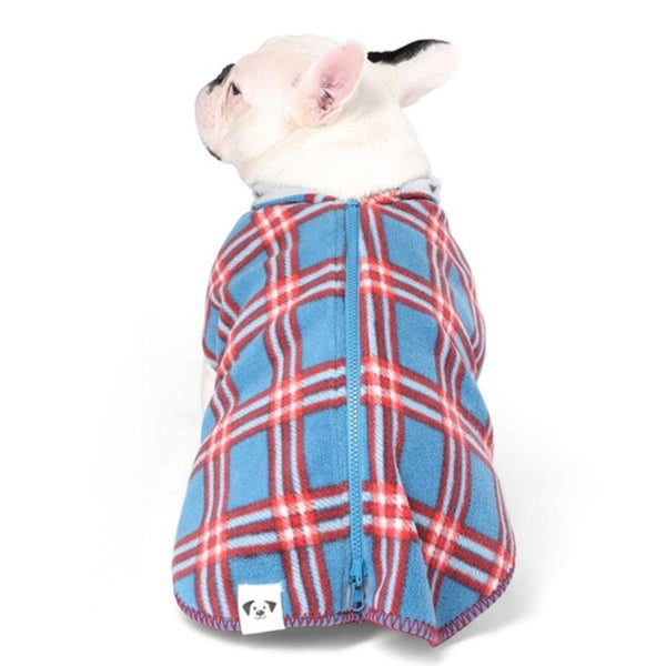 A French Bulldog models a blue and red check fleece dog coat.