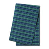 A green and blue check fleece dog blanket neatly folded.