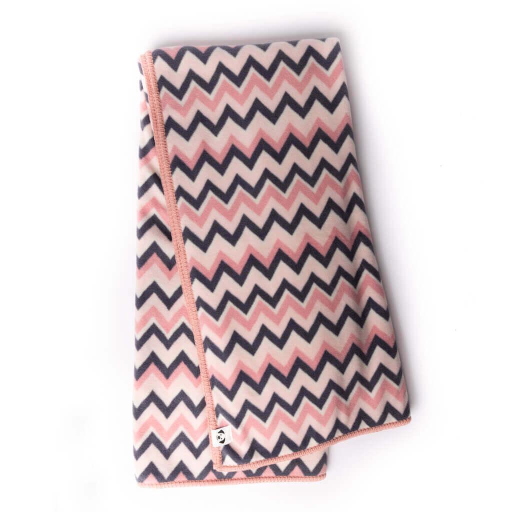 A pink stripe fleece blanket folded neatly.