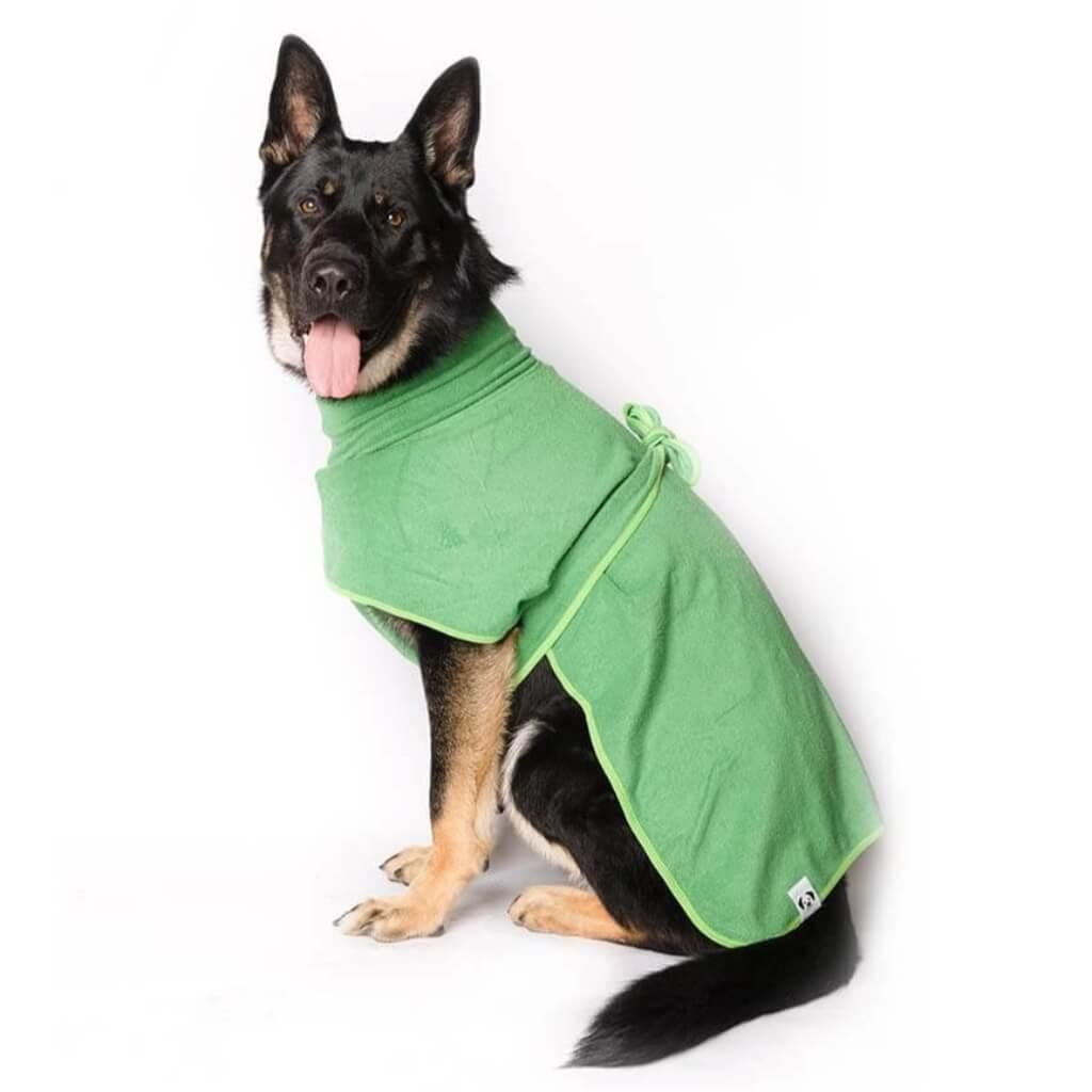 A German Shepherd wearing a green dog drying coat.