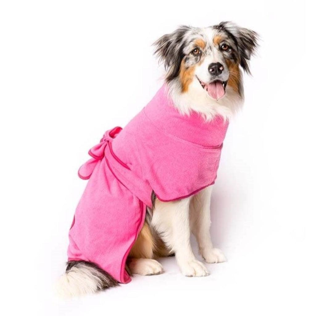 An Aussie Shepherd dog wearing a pink dog towel robe.